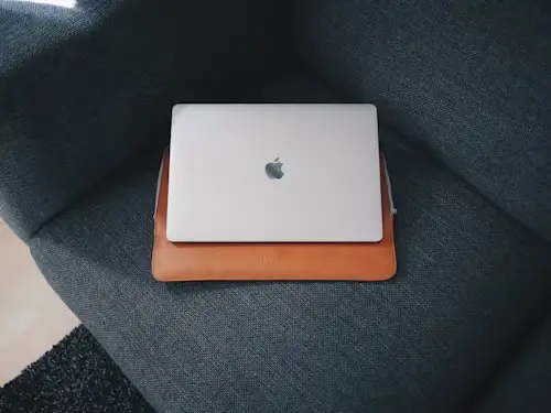 An apple MacBook pro case on navy blue cushion