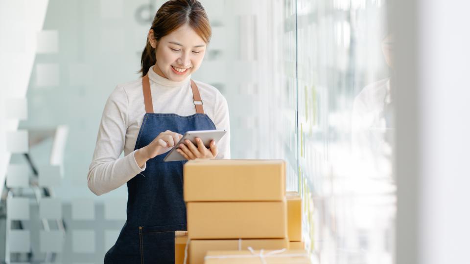 A lady holding an iPad and shopping online